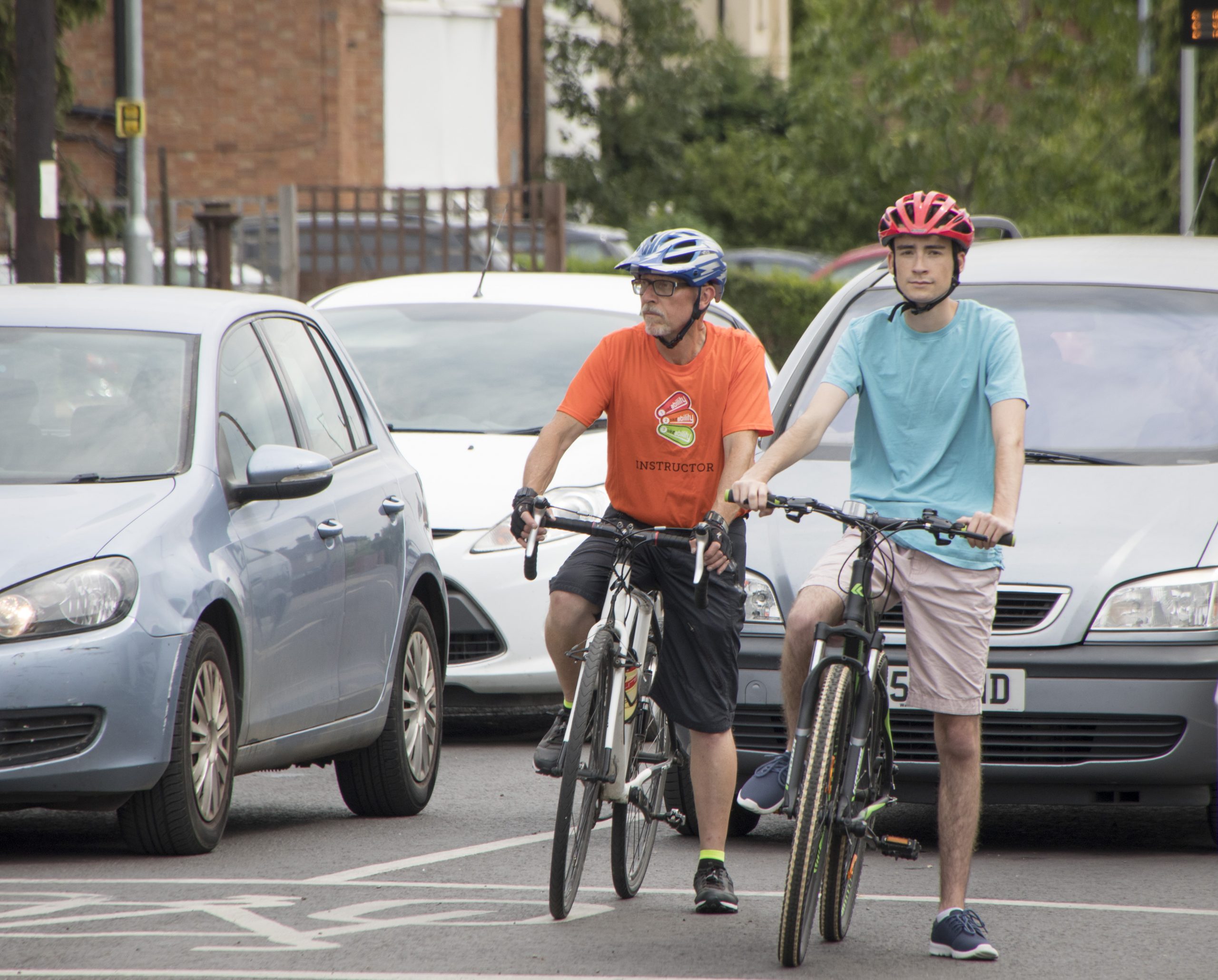 A teenage boy during his Bikeability Level 3 with an instructor on the road