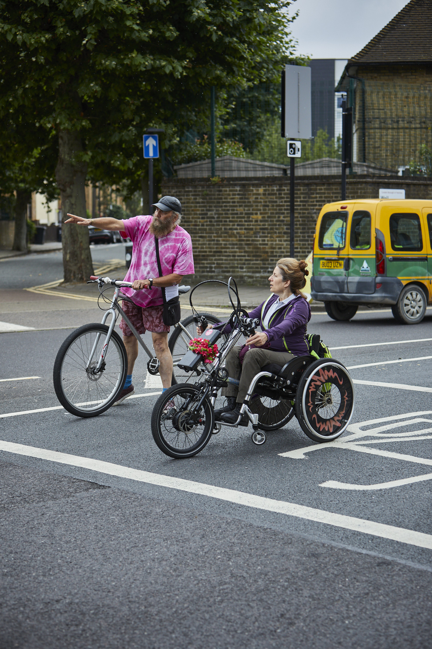 Instructor teaching a cyclist on trike to become an instructor