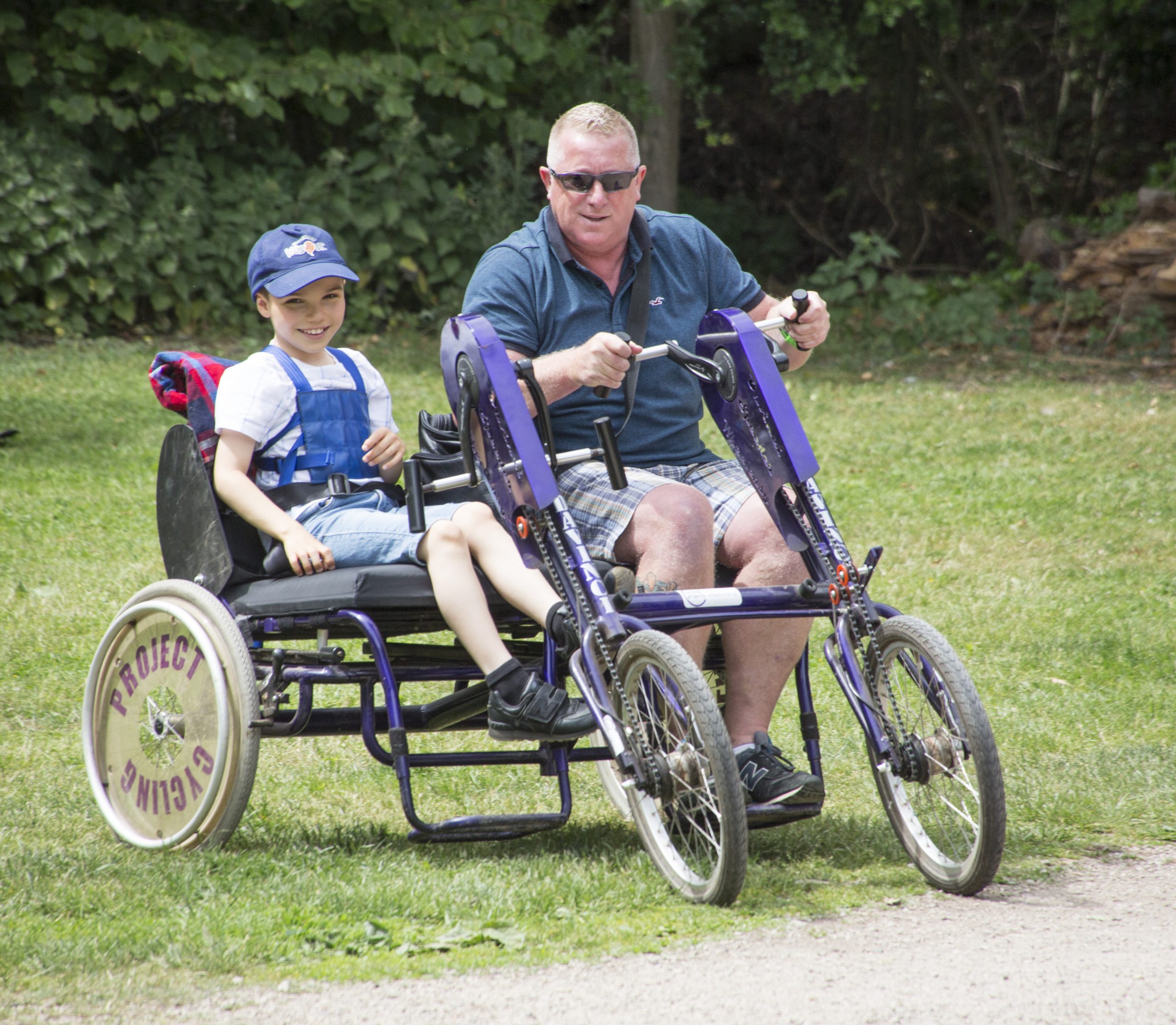 A child and man on a side by side bike