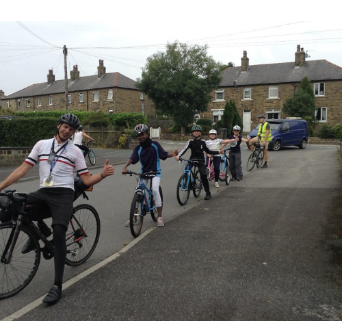 Children learning to ride bikes with a Bikeability instructor