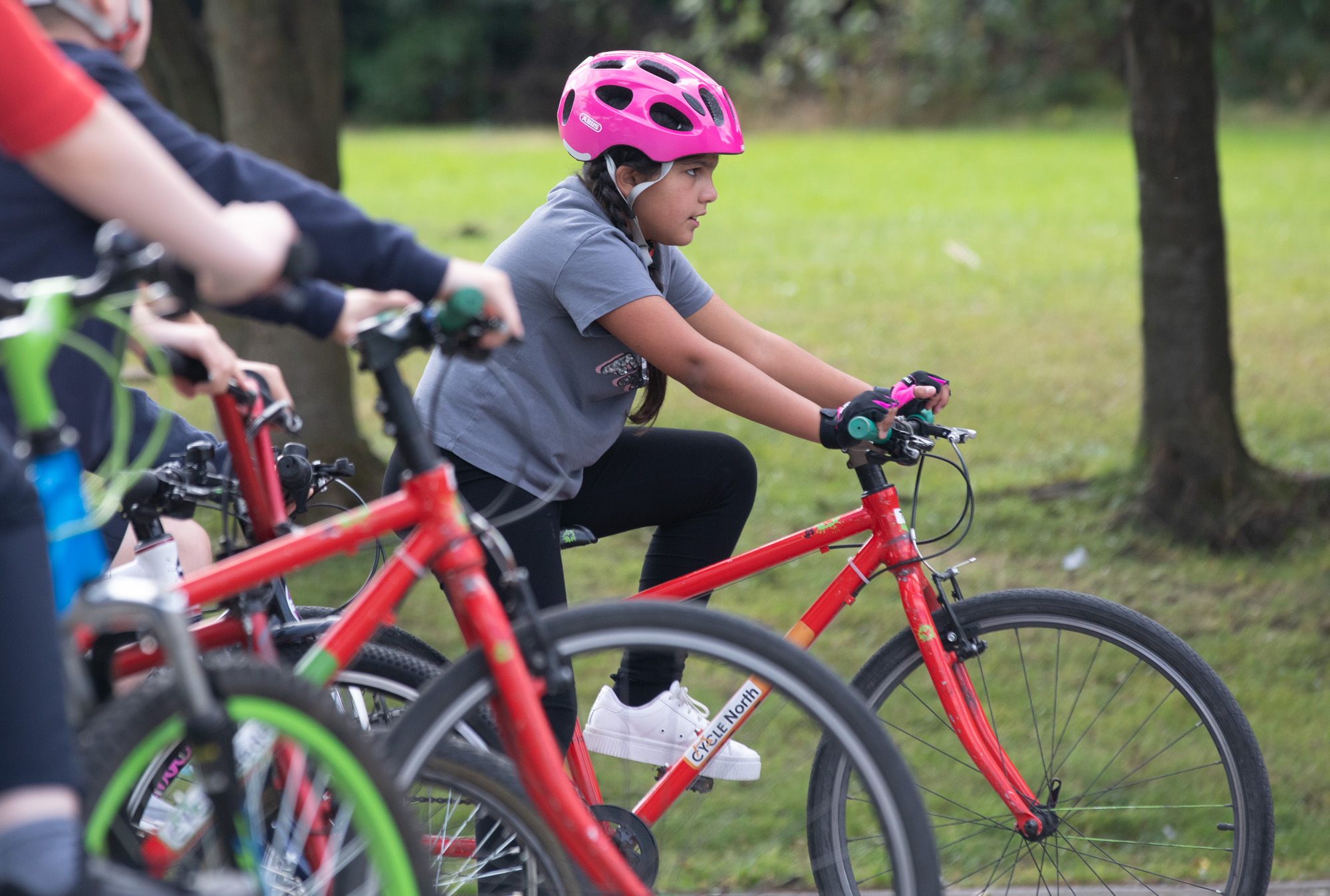 A group cycling together in a park