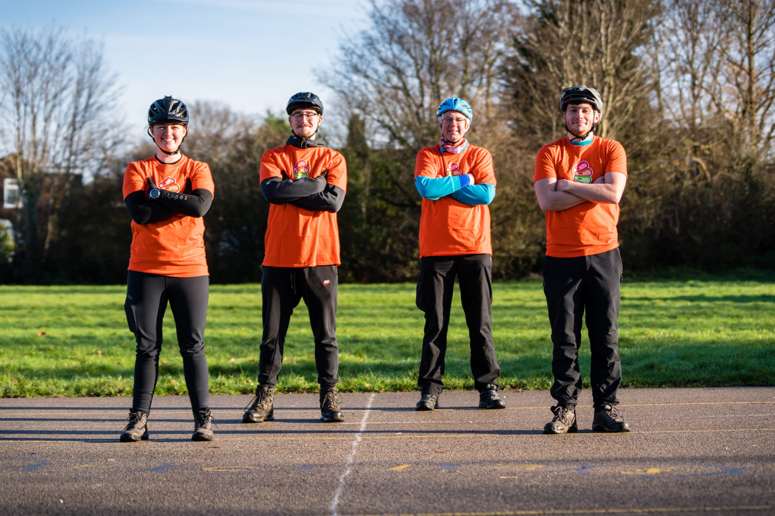 Four Bikeability instructors pose with crossed arms