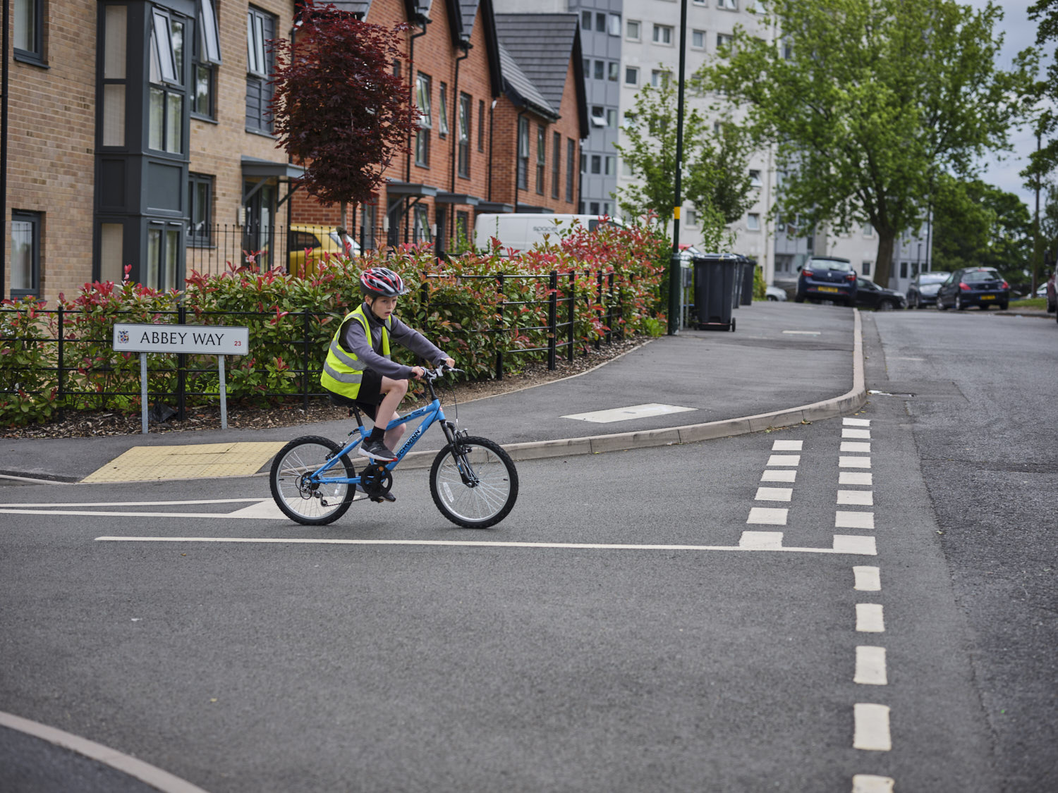 Young boy cycling to school on the road