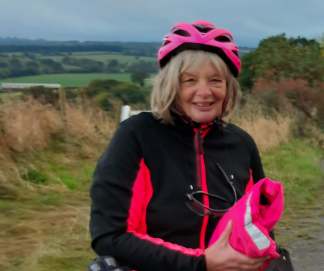 June Sawyer wearing a pink cycling helmet.