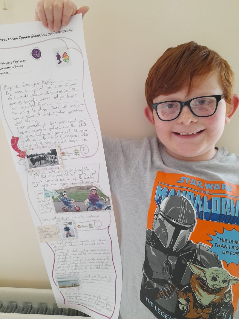 Samuel with his winning letter to the Queen