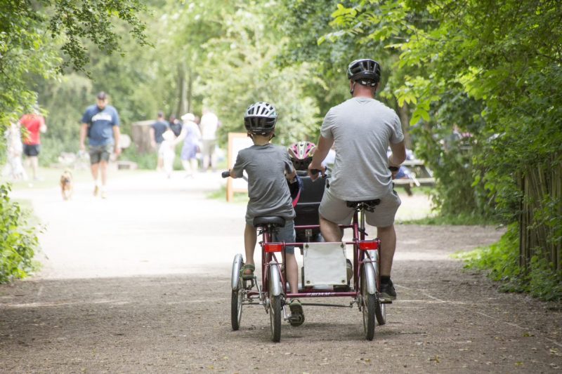 Family enjoying ride on adapted cycle