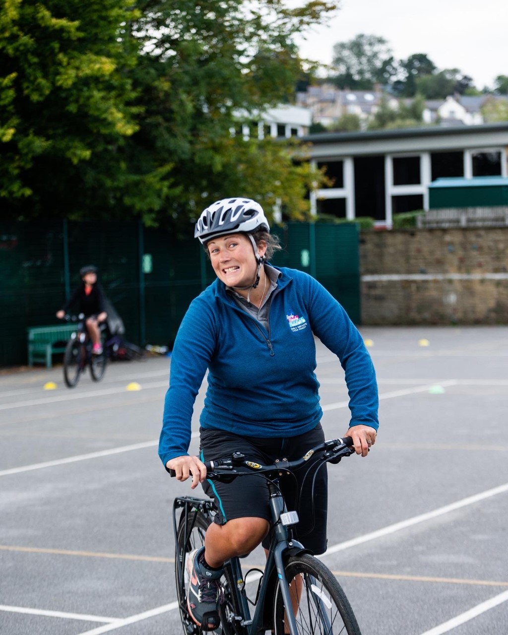 Emily grinning while riding her bike