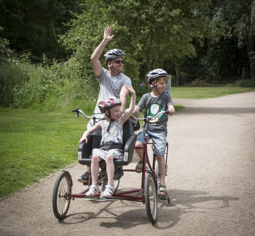 Family using an adapted trike to cycle