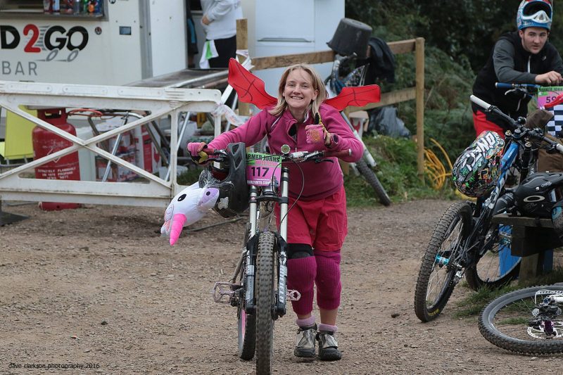 Hannah in fancy dress pushing her bike