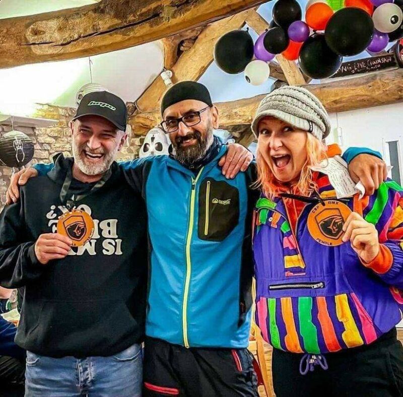 Emma posing with friends all wearing medals and smiling