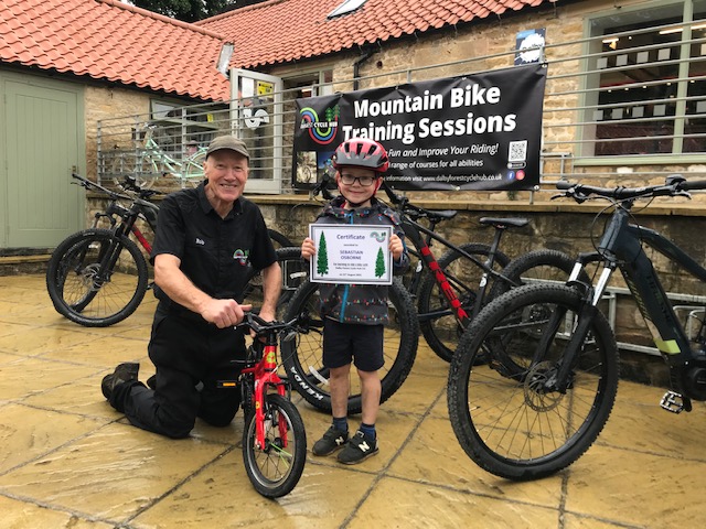 Rob and a pupil with their certificate after completing a learn to ride course