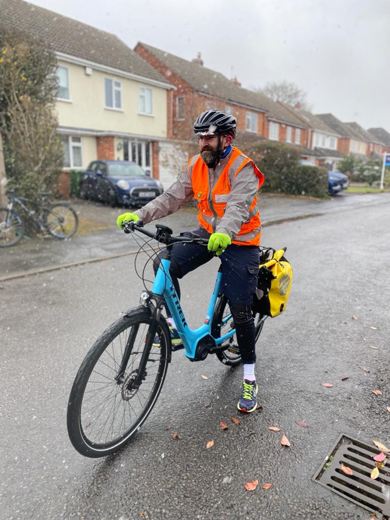 Instructor Perry on his blue Trek cycle in the sleet