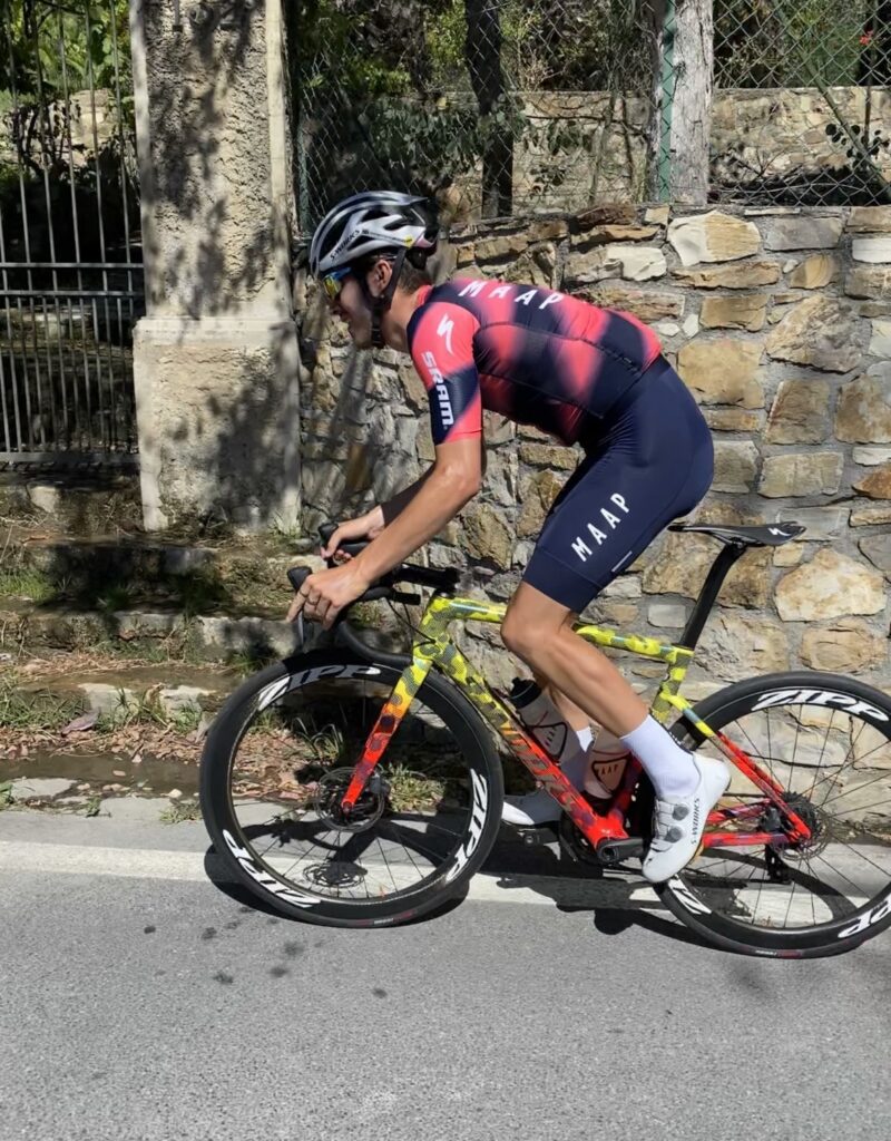 Jacques cycling on his road bike, he is wearing his Team Wiggins uniform