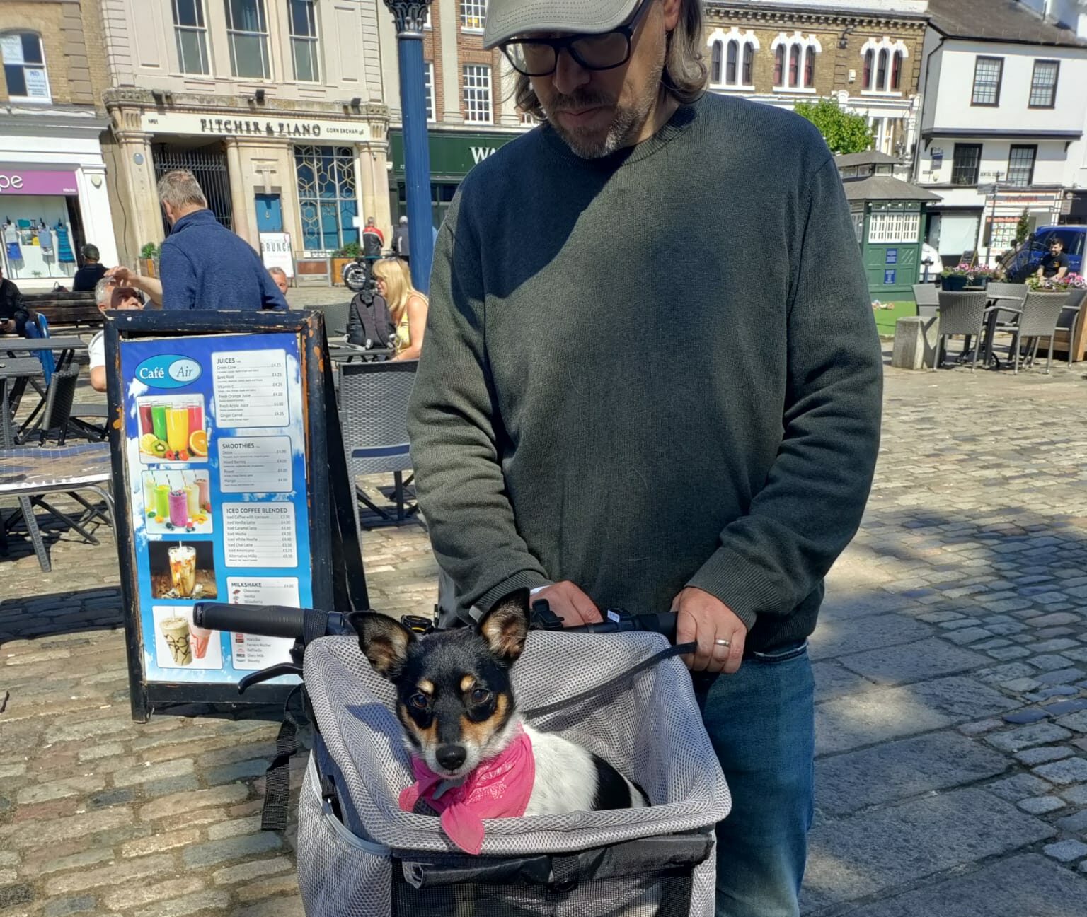 David with a dog in a basket on the front of his cycle