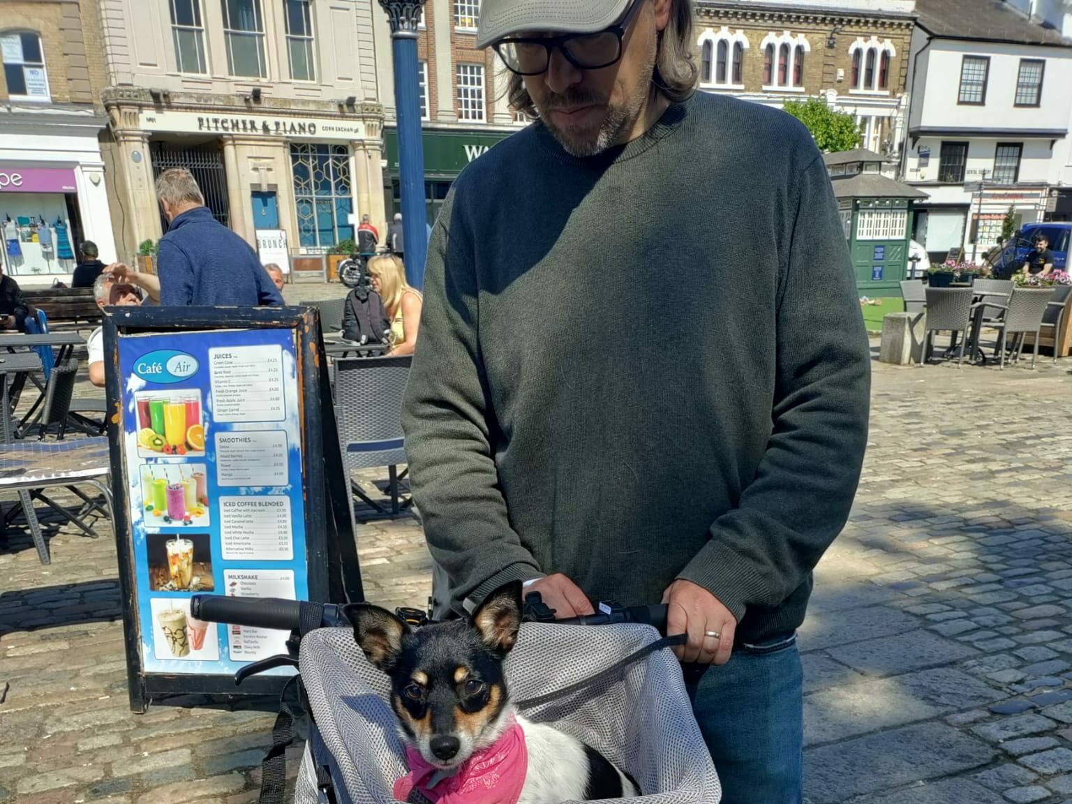 David with a dog in a basket on the front of his cycle