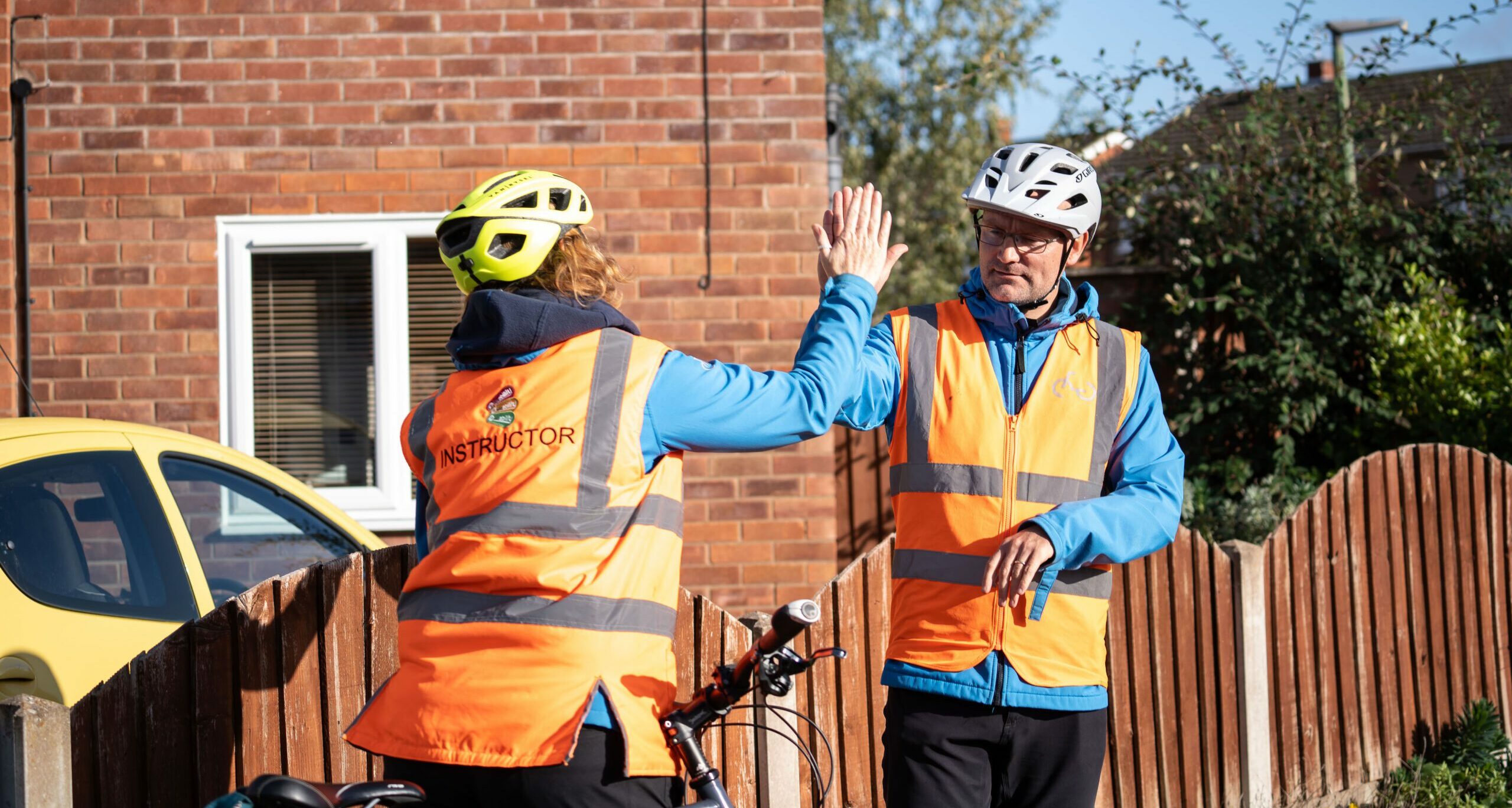 Two instructors sharing a hi-five