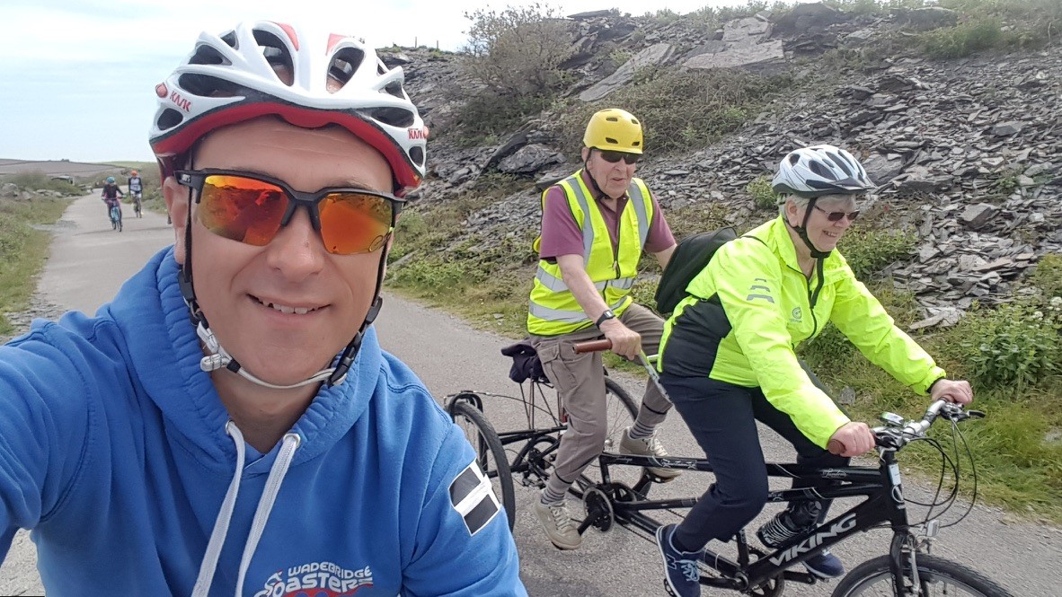 Phil on a cycle ride with friends on a tandem