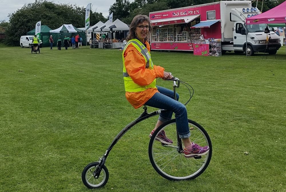 Katrin on a penny farthing